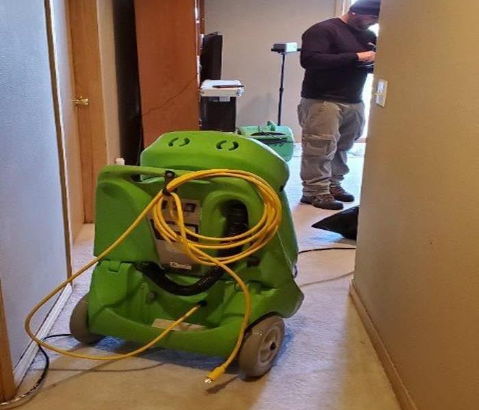 water extractor in hallway with man standing in the room